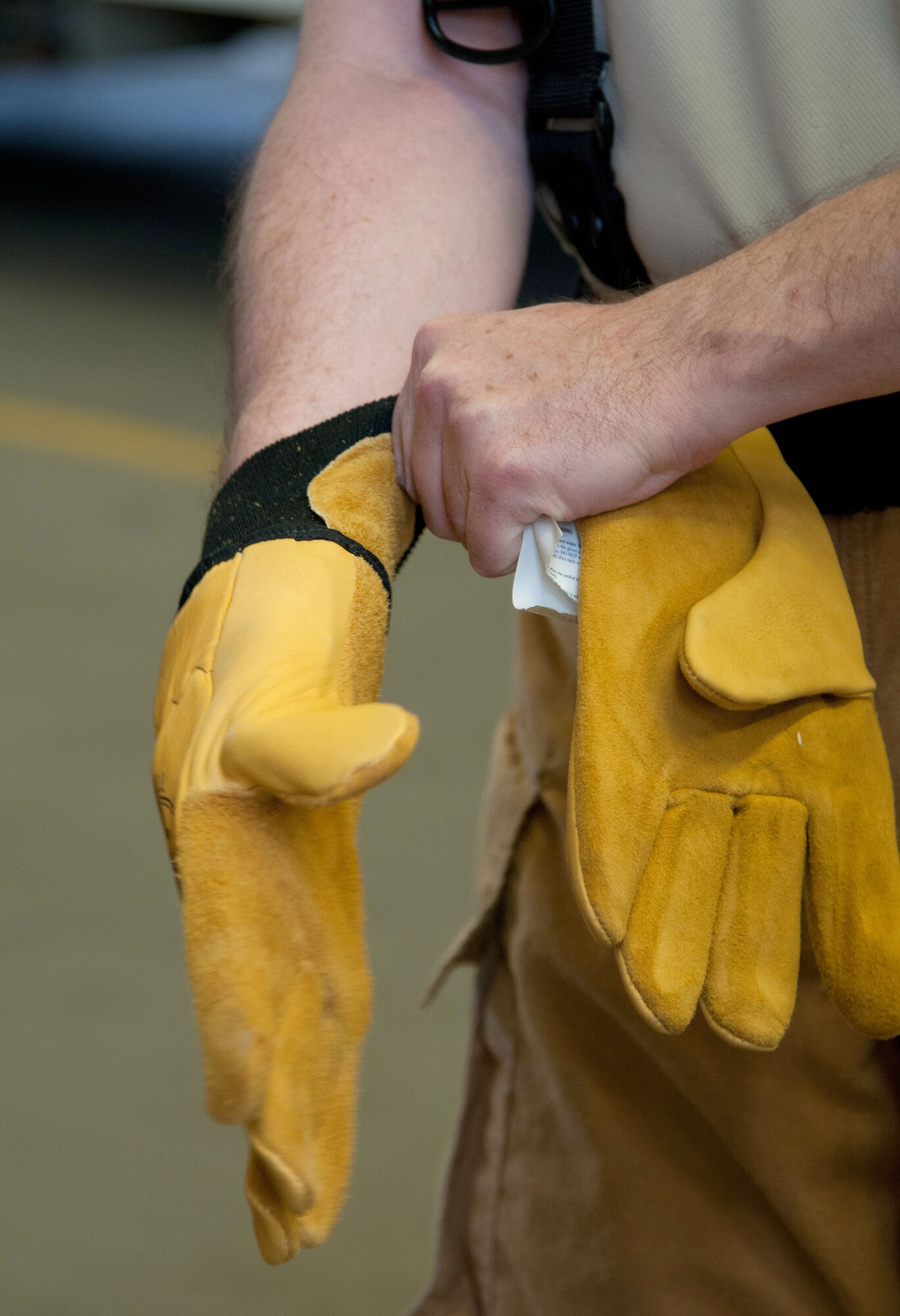Brig. Gen. Patrick X. Mordente, 86th Airlift Wing commander, puts on protective gloves prior to participating in a burn house training scenario at Ramstein Air Base, Germany, Nov. 19, 2014. The gloves and other safety gear protect firefighters while they battle the flames and smoke of a fire. Mordente participated in the training scenario alongside Chief Master Sgt. Frank H. Batten III, 86th AW command chief, and firefighters assigned to the 86th Civil Engineer Squadron. (U.S. Air Force photo/Senior Airman Timothy Moore)