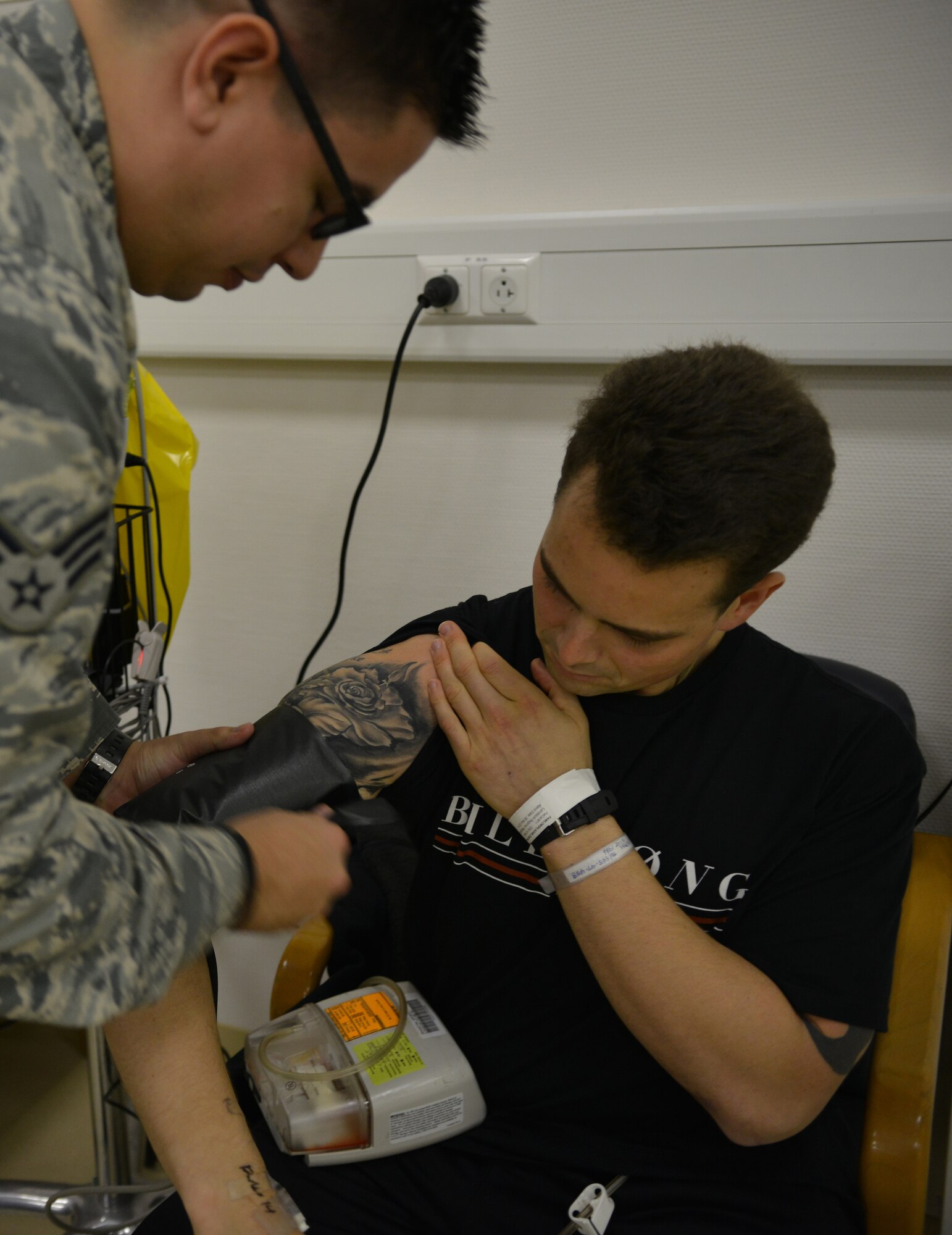 Senior Airman Michael Fromme, Contingency Aeromedical Staging Facility medical technician, checks a patient’s vitals upon his arrival at the CASF on Ramstein Air Base, Germany, Nov. 20, 2014. Arriving at work in the morning, Airmen from the CASF are dedicated to ensuring their mission runs smooth. (U.S. Air Force photo/Senior Airman Hailey Haux)