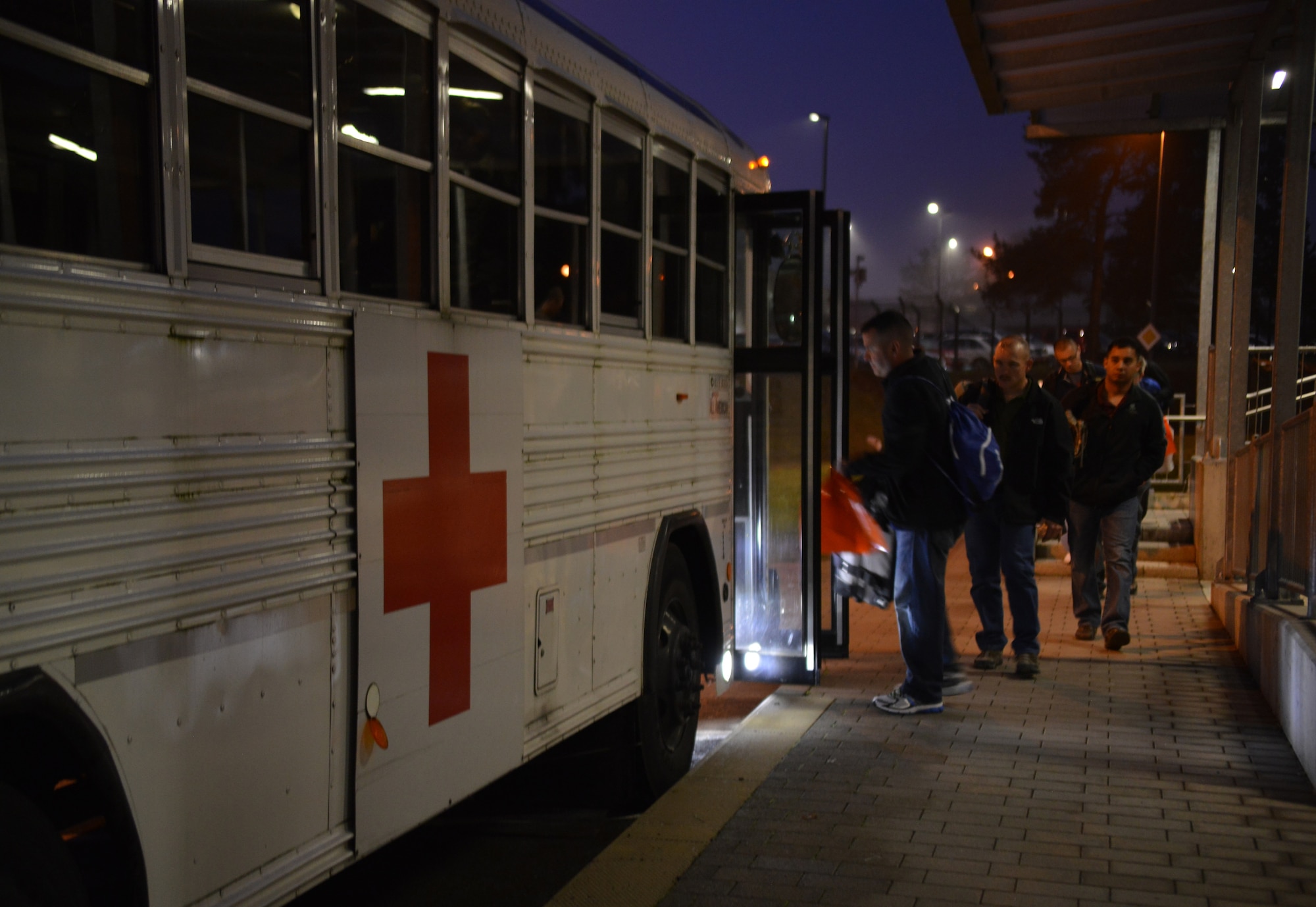 A group of wounded warriors load a medical bus on Landstuhl Regional Medical Center to be taken to Ramstein Air Base, Germany, Nov. 20, 2014. Airmen at the Contingency Aeromedical Staging Facilty ensure those injured down range have a smooth transition back home and into the arms of their loved ones. (U.S. Air Force photo/Senior Airman Hailey Haux)