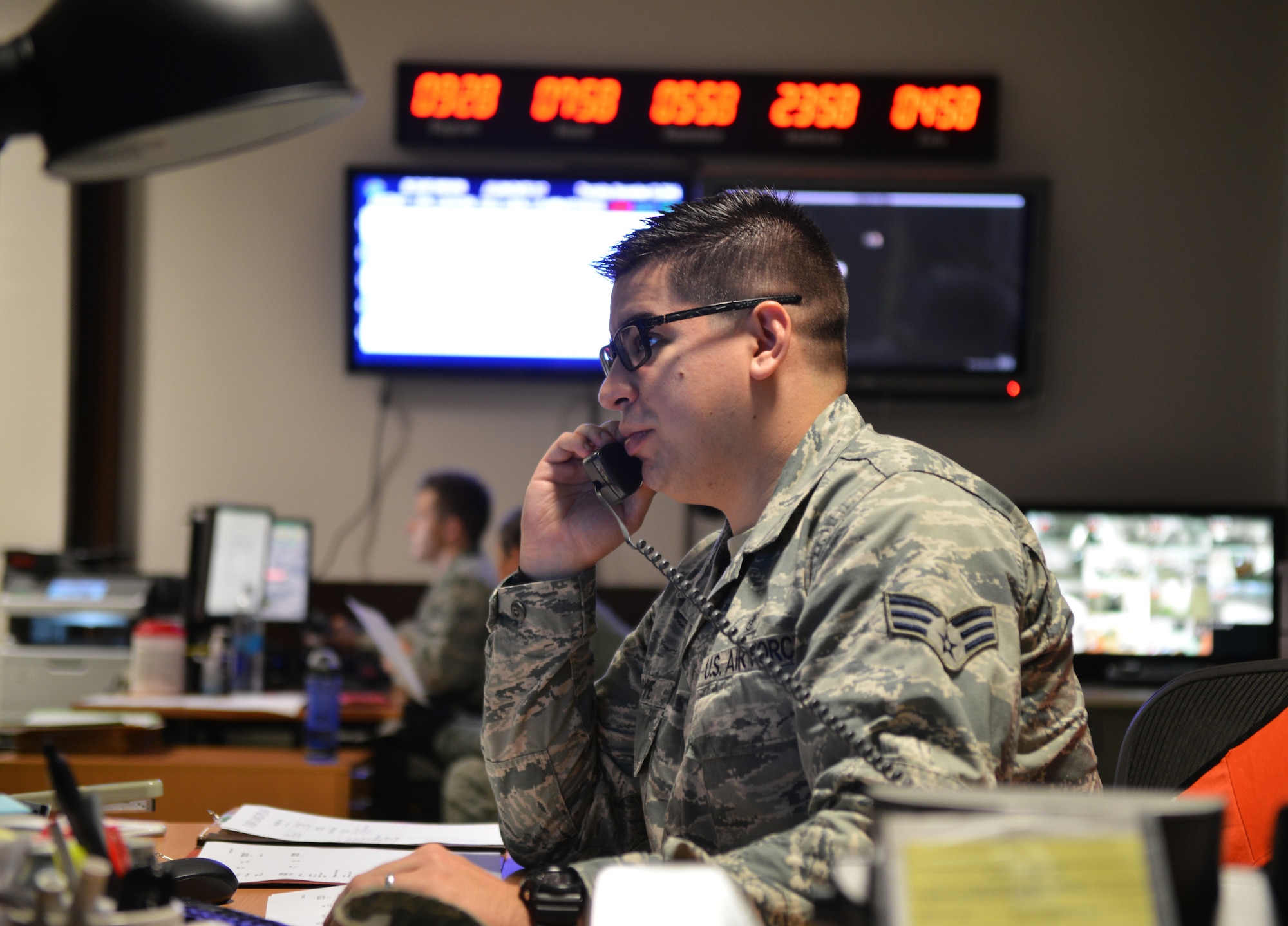 Senior Airman Michael Fromme, Contingency Aeromedical Staging Facility medical technician, makes a phone call in the early morning for an outbound mission on Ramstein Air Base, Germany, Nov. 20, 2014. Airmen at the CASF ensure those injured down range have a smooth transition back home and into the arms of their loved ones. (U.S. Air Force photo/Senior Airman Hailey Haux)