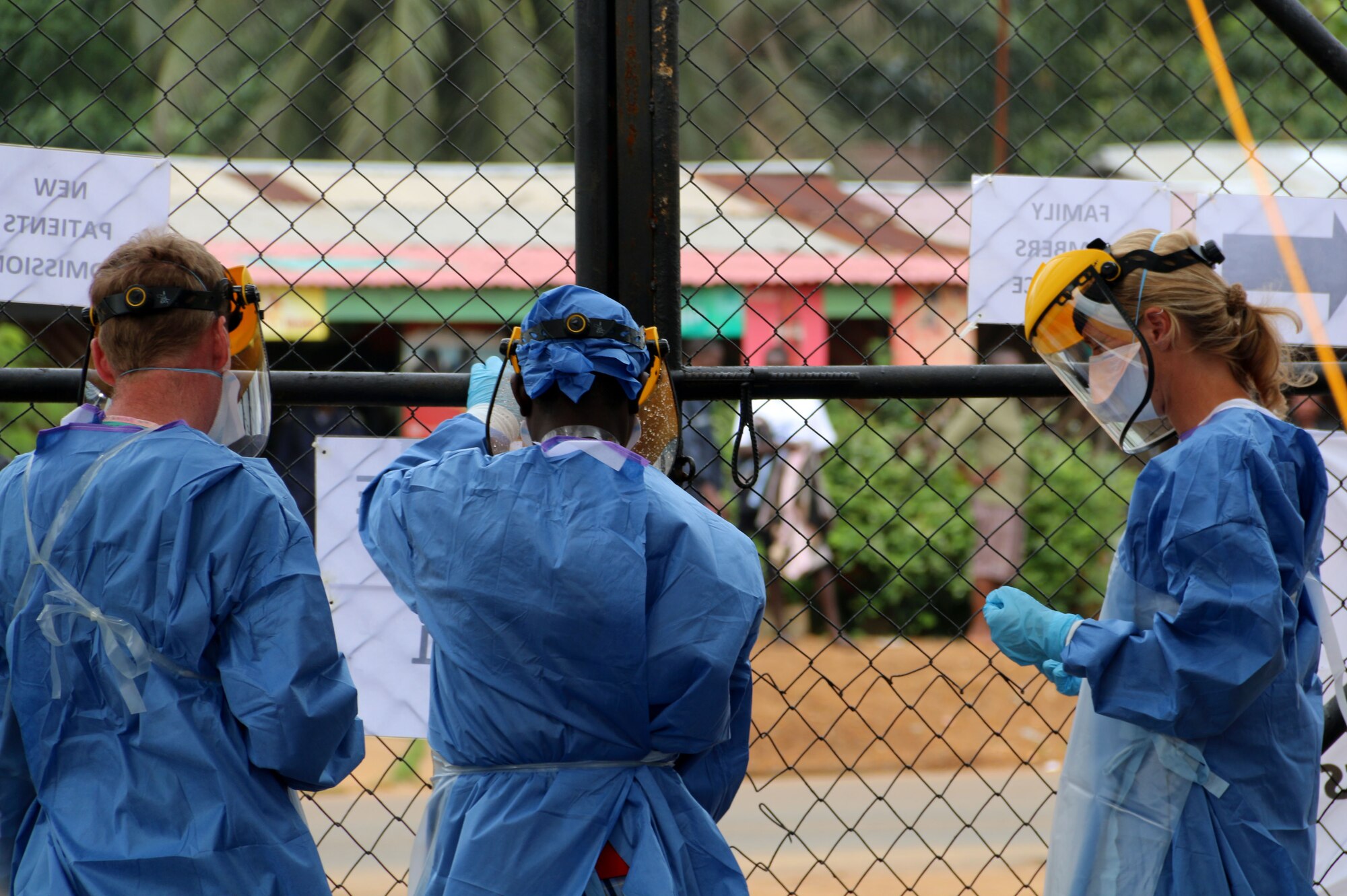 MONROVIA, Liberia – A group of health care workers hang signs on a fence at a field hospital in Monrovia, Liberia Sept. 19, 2014. The workers are among volunteers from around the world fighting the epidemic outbreak of Ebola. (Photo/Maj. Francis Obuseh)