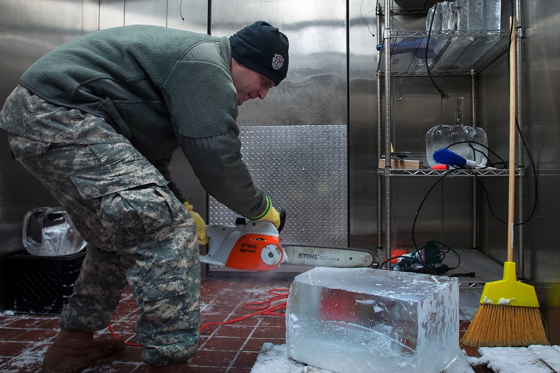 Army Spc. Matt Squairs shears off a corner from a block of ice he is sculpting into a pumpkin on Eglin Air Force Base, Fla., Nov. 21, 2014. Squairs, a culinary specialist assigned to the 7th Special Forces Group Airborne’s Group Support Battalion, and other cooks spent more than two weeks preparing a Thanksgiving meal held in the unit’s dining facility.