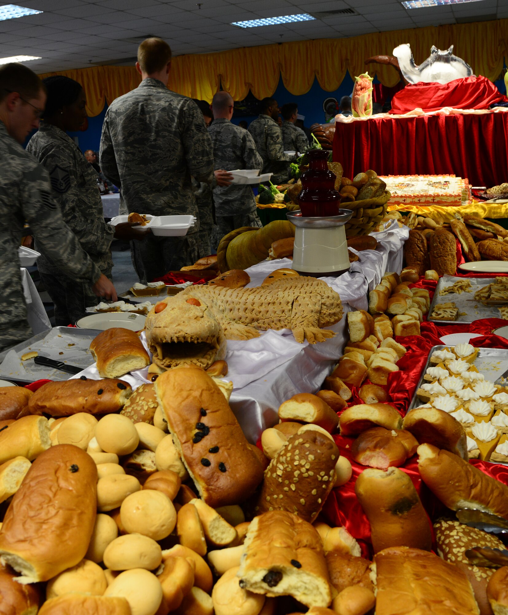 Desserts and breads line a table during the annual Thanksgiving meal Nov. 27, 2014, at Al Udeid Air Base, Qatar. The base dining facility staff prepared Thanksgiving meals more than 9,000 servicemembers. (U.S. Air Force photo by Senior Airman Kia Atkins)