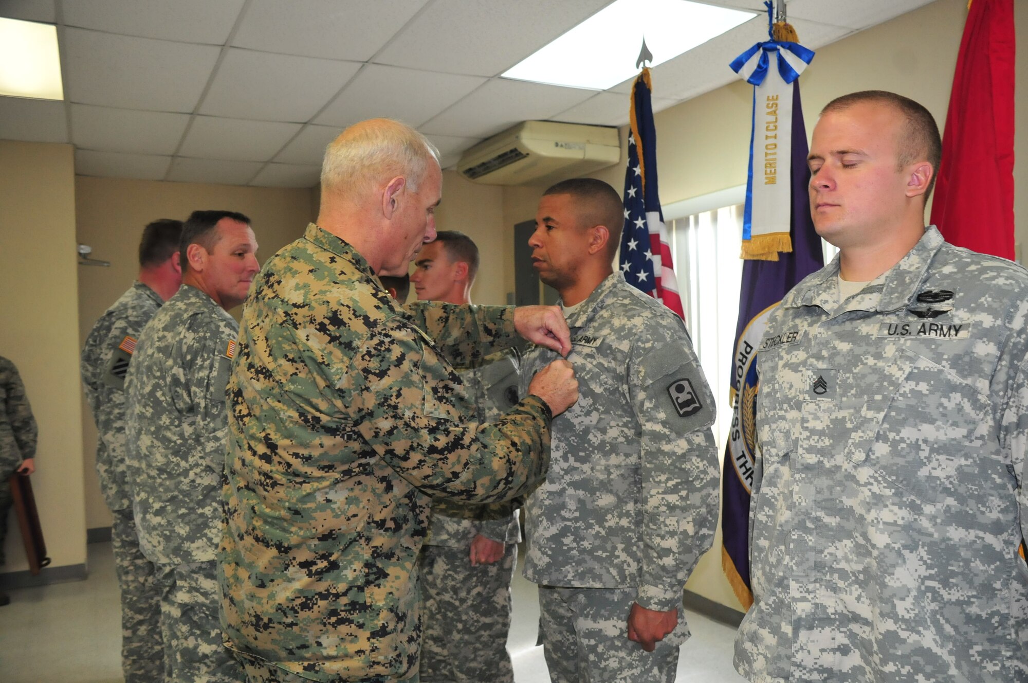 U.S. Marine General John Kelly, Commander, U.S. Southern Command, presents five service members with the Army Commendation Medal at Soto Cano Air Base, Honduras, Nov. 27, 2014.  The service members were recognized for their distinguished achievements during their tour here.  General Kelly visited Soto Cano Air Base to celebrate Thanksgiving with the service members here. (U.S. Air Force photo by Capt. Connie Dillon)