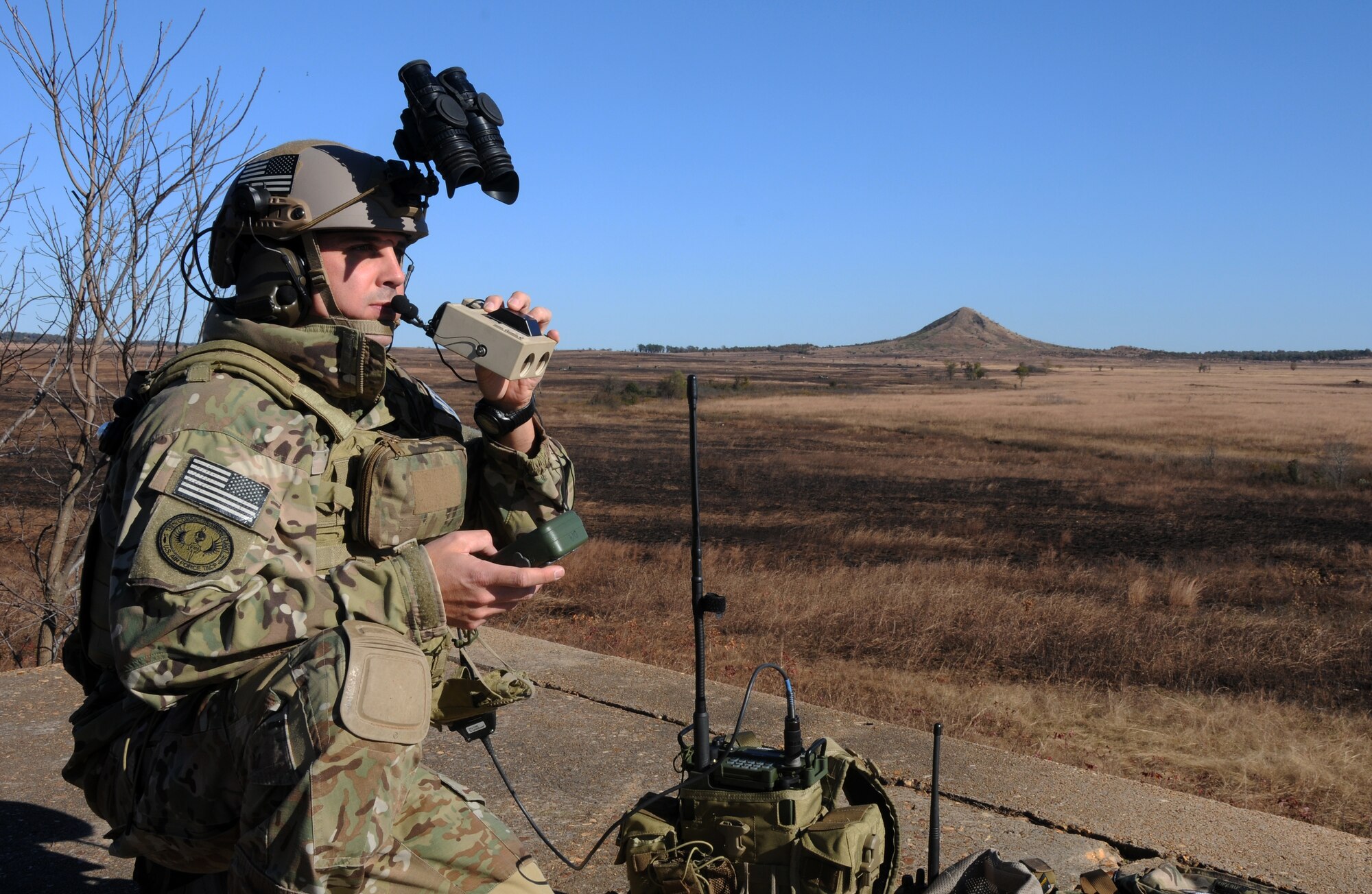 Tech. Sgt. Robert G. Ellis II scans the horizon at 188th Wing Detachment 1 Razorback Range at Fort Chaffee Joint Maneuver Training Center, Ark., Nov. 6, 2014. Ellis was selected as The Flying Razorback spotlight for December 2014. Ellis is the 188th’s joint terminal attack controller (JTAC) trainer. He trains Special Operations JTACs from every branch to ensure they maintain their certifications and they’re prepared for future combat deployments. (U.S. Air National Guard photo by Airman 1st Class Cody Martin/Released)