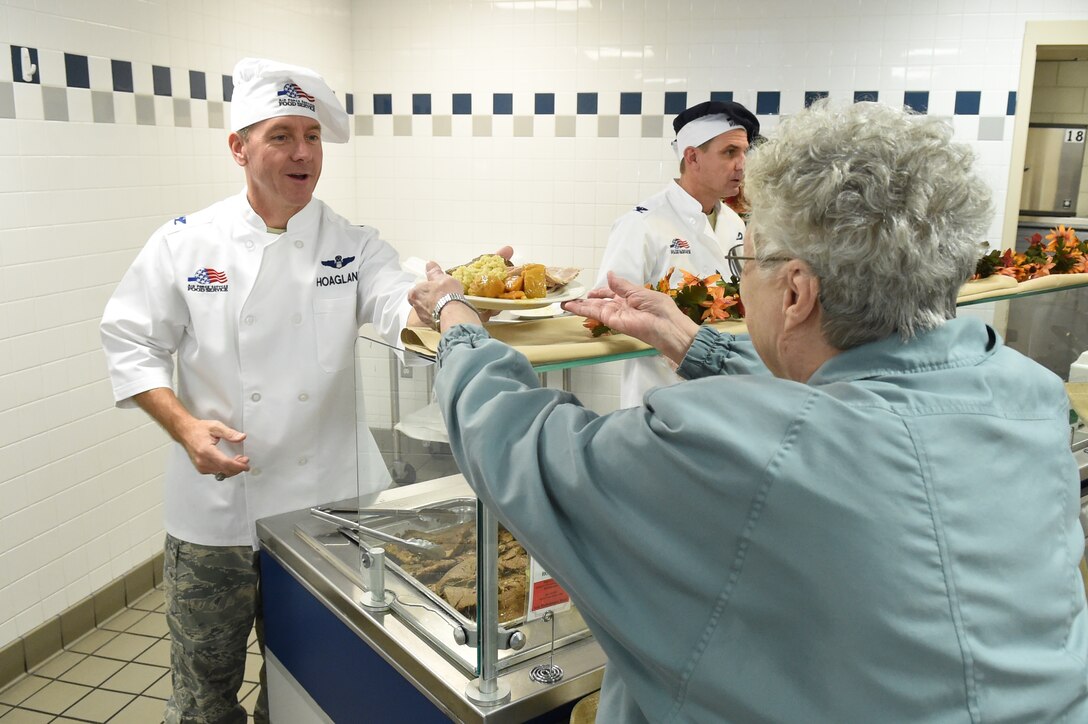 Col. Brad Hoagland, 11th Wing/Joint Base Andrews commander, helps serve lunch to dining facility patrons on Thanksgiving at JBA, Md., Nov. 27, 2014. Base leadership traditionally serves food at the DFAC on popular holidays for fellow airmen. (U.S. Air Force photo/Airman 1st Class Joshua R. M. Dewberry) 