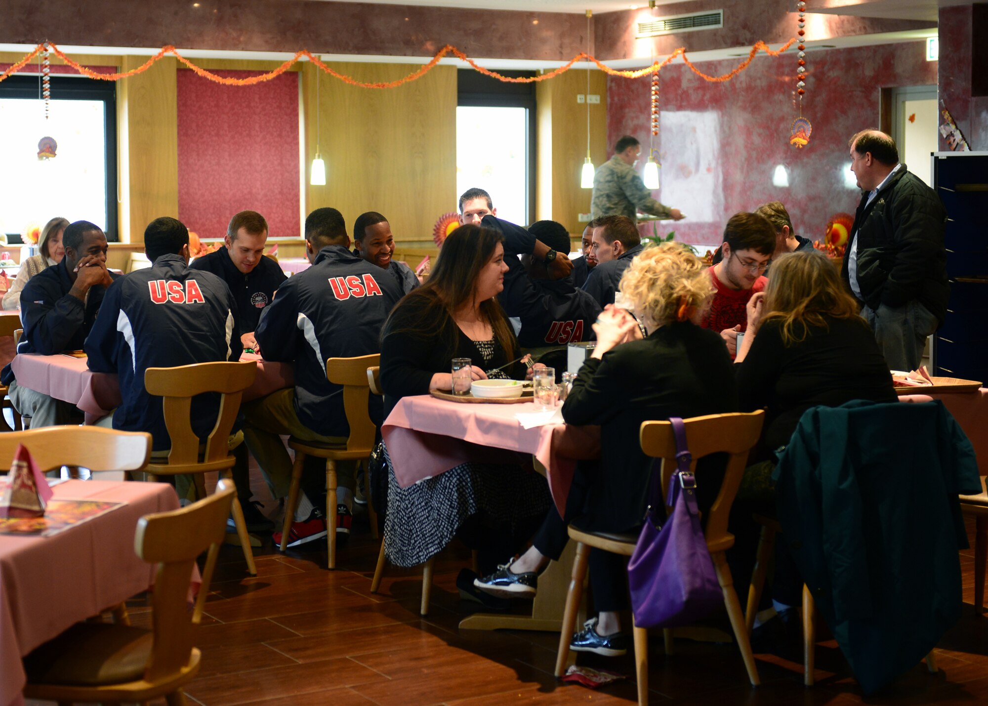 Airmen and families enjoy a traditional Thanksgiving meal at the Rheinland Inn Dining Facility on Ramstein Air Base, Germany, Nov. 27, 2014. The dining facility is open during all major holiday including Thanksgiving to ensure Airmen have a place to celebrate while separated from their families. (U.S. Air Force photo/Staff Sgt. Kris Levasseur)