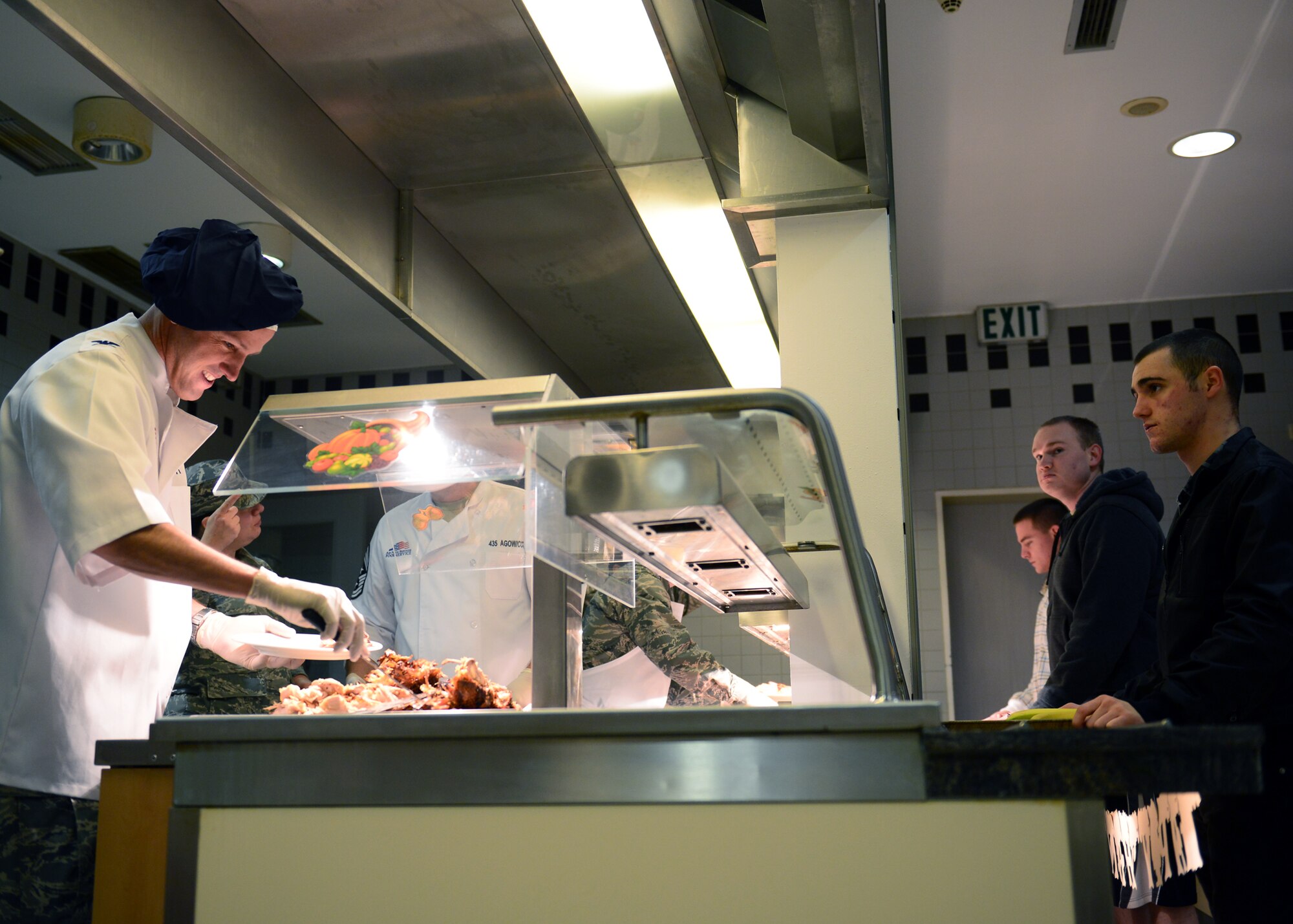 Col. Leslie Smith, 86th Airlift Wing vice commander, serves turkey to KMC members on Thanksgiving Day at the Rheinland Inn Dining Facility on Ramstein Air Base, Germany, Nov. 27, 2014. Traditionally, the leaders of the 86th AW serve a Thanksgiving meal to the Airmen and their families as a way to thank them for their hard work and dedication. (U.S. Air Force photo/Staff Sgt. Kris Levasseur)