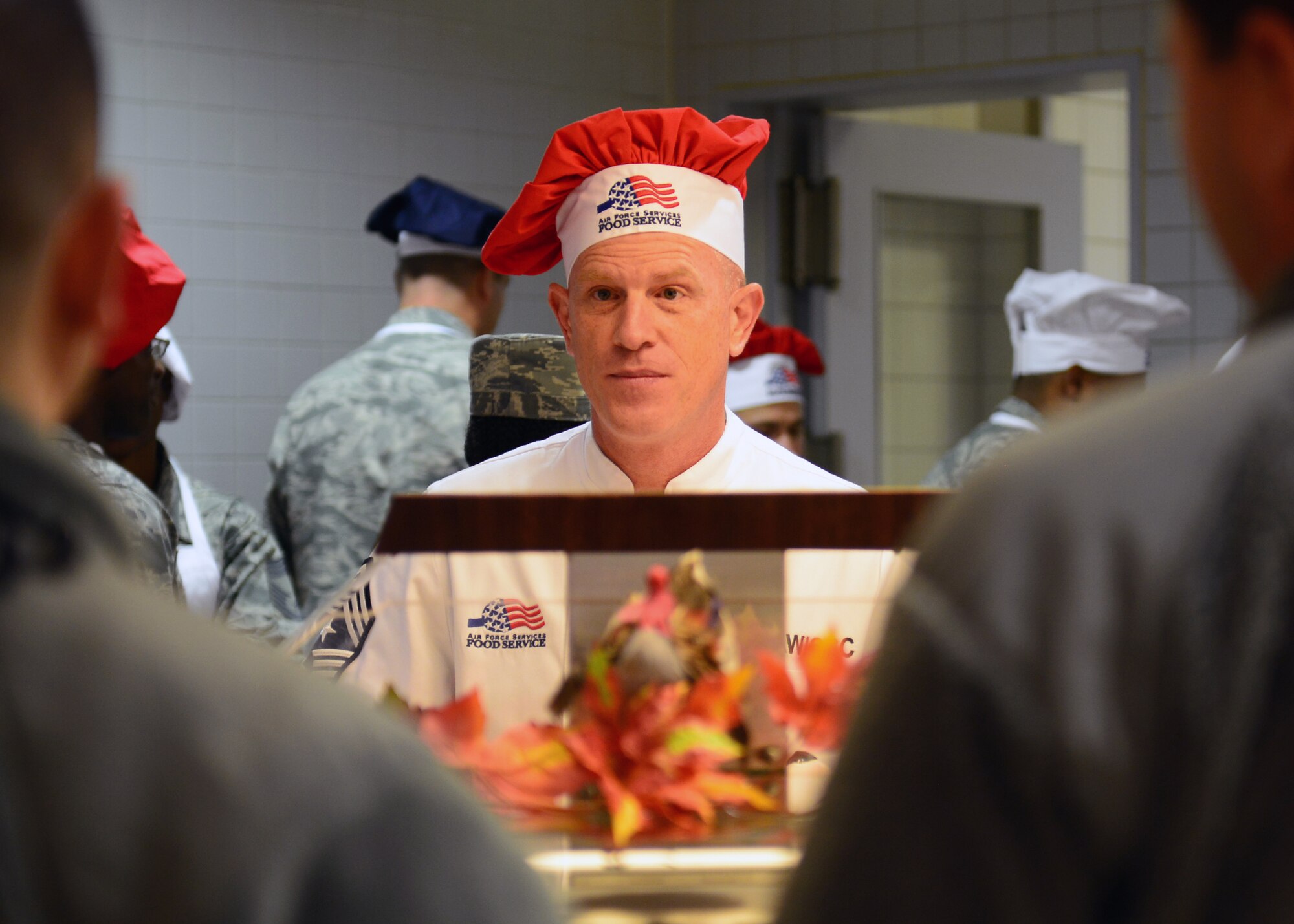 Chief Master Sgt. Frank Batten III, 86th Airlift Wing command chief, asks Airman if they would like roast beef on Thanksgiving Day at the Rheinland Inn Dining Facility on Ramstein Air Base, Germany, Nov. 27, 2014. The Thanksgiving meal provided Airmen with a taste of home while separated from their families. (U.S. Air Force photo/Staff Sgt. Kris Levasseur)