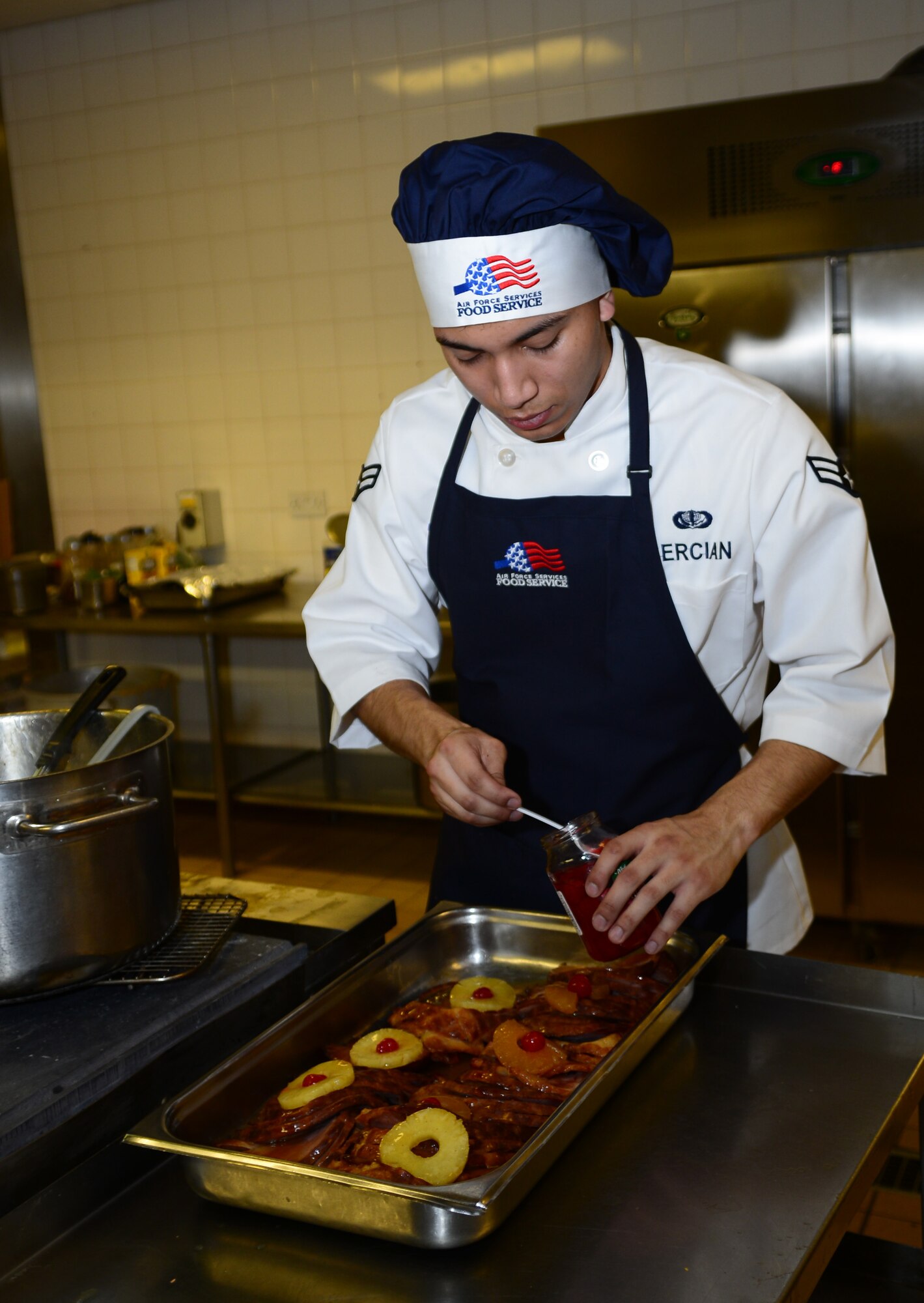 U.S. Air Force Airman 1st Class Victor Bercian, 100th Force Support Squadron food specialist from Silver Spring, Md., prepares food for the Thanksgiving lunch Nov. 27, 2014, at the Gateway dining Facility on RAF Mildenhall, England. The special meal was prepared in celebration of the American holiday and fed more than 250 members of Team Mildenhall. (U.S. Air Force photo by Airman 1st Class Jonathan Light/Released)