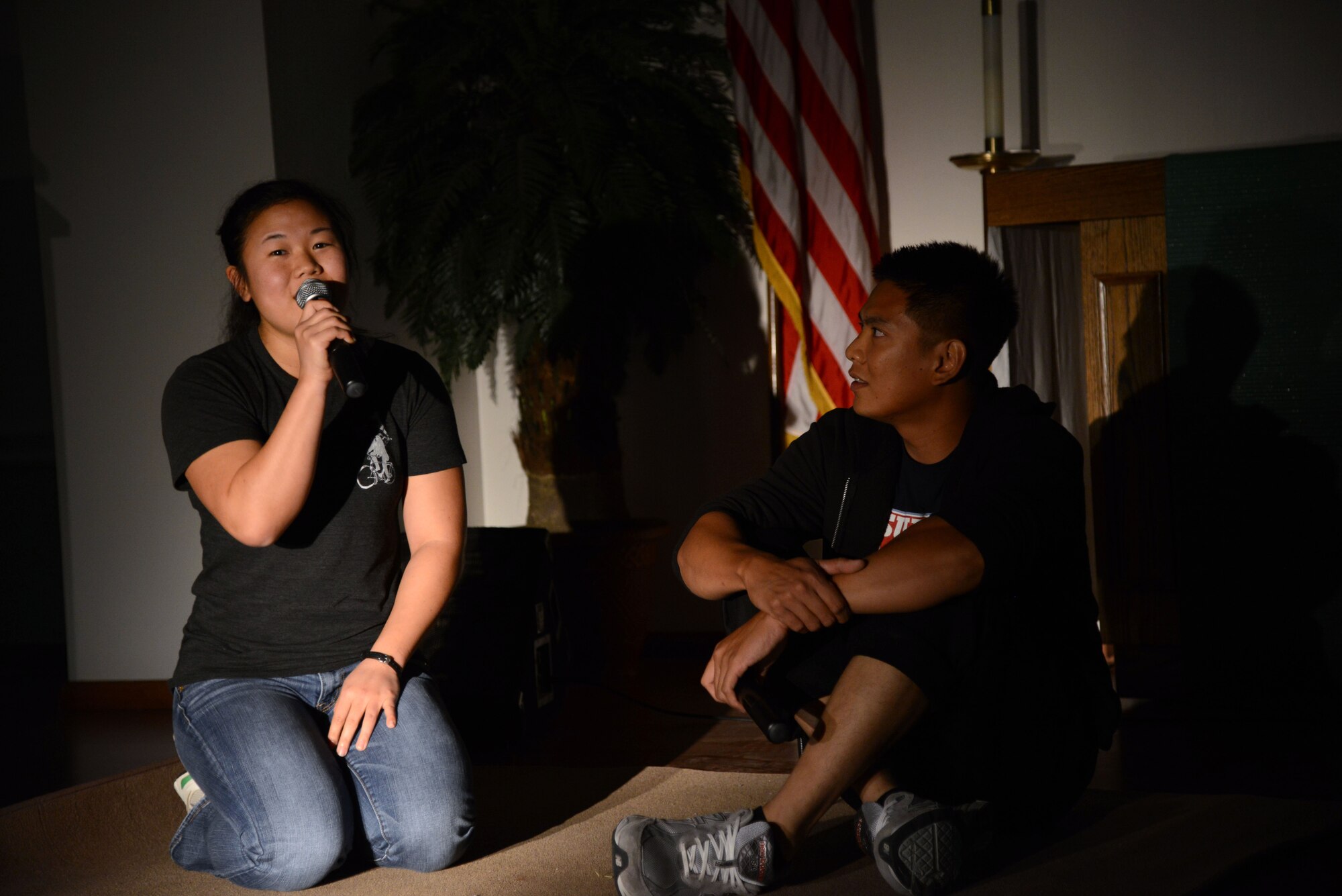 SOUTHWEST ASIA - Capt. Kathleen Lau, 387th Expeditionary Support Squadron (left), and Staff Sgt. Zyron Maniego, 386th Expedetionary Civil Engineer Squadron sing "A whole new world" during a chapel sponsored talent showcase here Nov. 21, 2014. Participants used music, poetry and other talents to show thanks during this holiday season. (U.S. Air Force photo by Tech. Sgt. Jared Marquis/released)