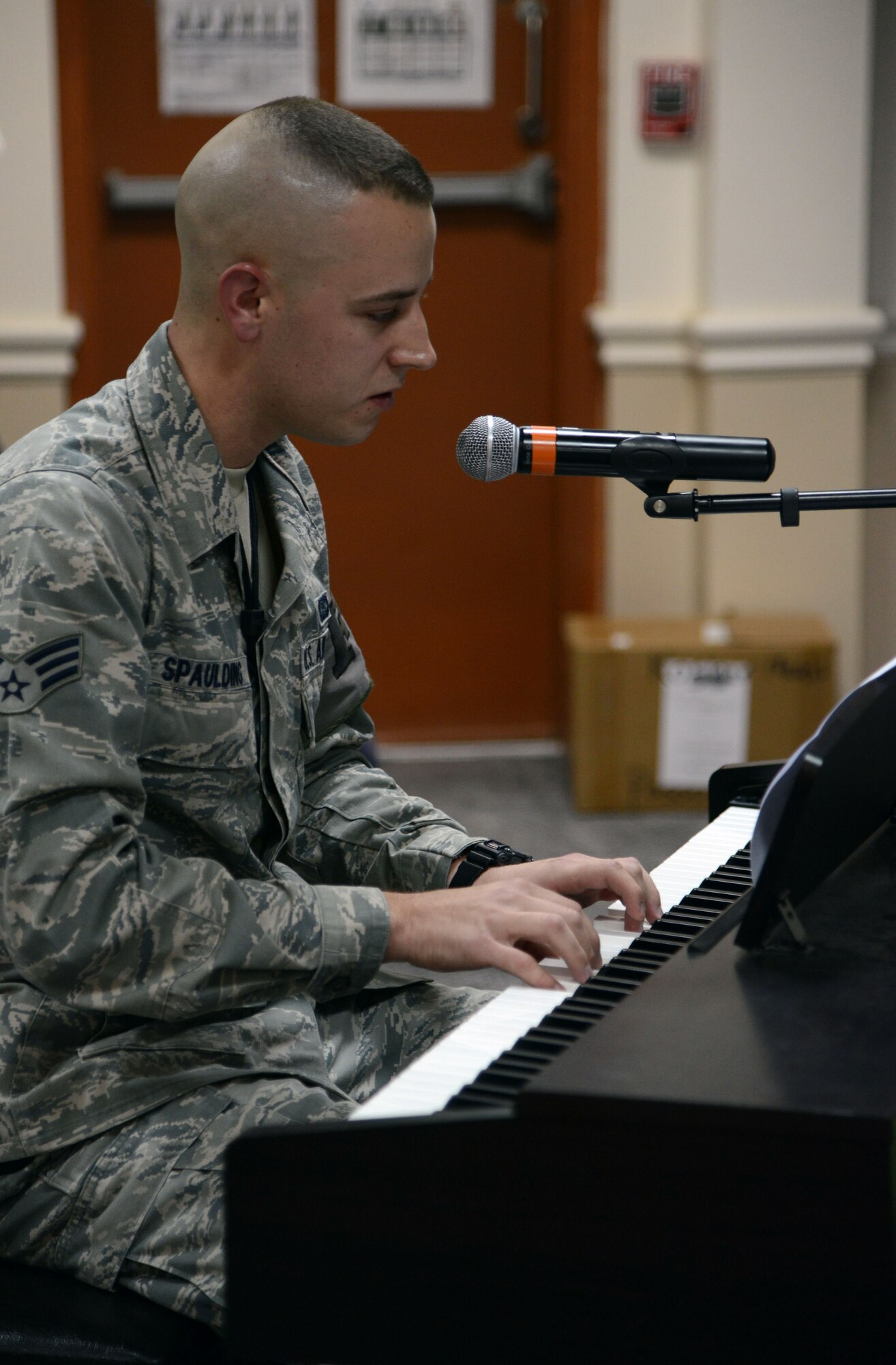 SOUTHWEST ASIA - Senior Airman Landon Spaulding, 386th Expeditionary Civil Engineer Squadron, plays piano and sings during a chapel-sponsored talent showcase Nov. 21, 2014. Marauders used music, poetry and other talents to show their thanks during the holiday season. (U.S. Air Force photo by Tech. Sgt. Jared Marquis/released)