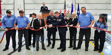 U.S. Sen. Herb Kohl, fourth from left, assists Station Fire Chief Senior Master Sgt. Gary Peck, fourth from right, along with local dignitaries and fire/rescue personnel, to separate a symbolic fire hose during the dedication ceremony of the 115th Fighter Wing airport fire station in Madison, Wis. The expansion and complete renovation of the Wisconsin Air National Guard Fire/Rescue Station at the Dane County Regional Airport was recognized during an official dedication ceremony Feb. 19, 2010.