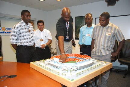 Federal Bureau of Investigations Agent Connally Brown and members of the Trinidad & Tobago State Partnership Program toured the Super Bowl Joint Operations Center during Super Bowl week. Brown, who works at the U.S. Embassy in Trinidad & Tobago explains the positioning of security cameras using a model of the Super Bowl stadium.