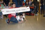 Family members anxiously wait for Soldiers from the 1161st Transportation Company from Ephrata, Wash., to arrive at the Spokane International Airport March 2, 2010.