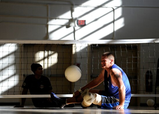 Retired Tech. Sgt. Patrick Young pushes through pain during a wounded, ill or injured warrior sitting volleyball practice, Nov. 18, 2014 at the Joint Base Andrews West Fitness Center. Young was injured during a motorcycle accident after returning from a deployment to Iraq. (U.S. Air Force photo/Tech. Sgt. Brian Ferguson)