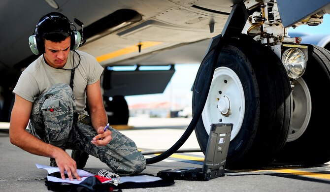 Senior Airman Daryn Petrie annotates fuel servicing to a KC-135 Stratotanker at MacDill Air Force Base, Fla., Oct. 30, 2014. The KC-135 can hold up to 200,000 lbs. of fuel and can be used as a medical evacuation aircraft. Petrie is a 6th Aircraft Maintenance Squadron crew chief. (U.S. Air Force photo/Senior Airman Melanie Bulow-Gonterman)