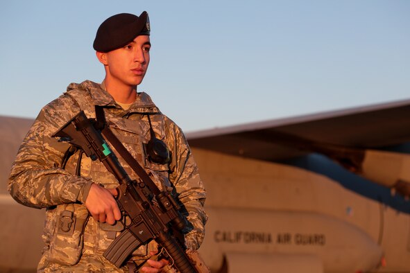 Airman 1st Class Abdiel Rivera walks the perimeter of a C-130J Hercules, Nov. 19, 2014. The aircraft is from 146th Airlift Wing based out of Channel Islands Air National Guard Base, Oxnard, Calif. Rivera is a security forces specialist from the New Jersey Air National Guard's 177th Security Forces Squadron. (U.S. Air National Guard photo/Tech. Sgt. Matt Hecht)