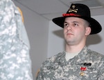 Spc. Christopher M. "Kit" Lowe receives the Bronze Star Medal with "V" Device during a ceremony in Doss Memorial Hall at Walter Reed Feb. 26, 2010. Lowe is recovering at Walter Reed from wounds he received as a result of actions he took during the combat operations in Afghanistan.