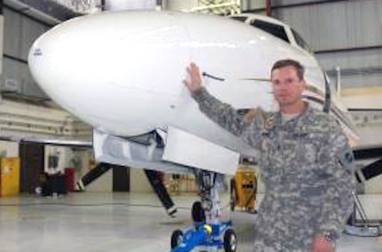 Colorado Army National Guard Chief Warrant Officer 4 Timothy Ames, commander of Detachment 33, stands next to the unit's Fairchild C-26 Metroliner fixed-wing turboprop air transport plane. He and four other members of his unit flew Department of Defense contractors to and from Florida and Haiti in support Operation Unified Response - the U.S. military's response to the 2010 Haiti earthquake.