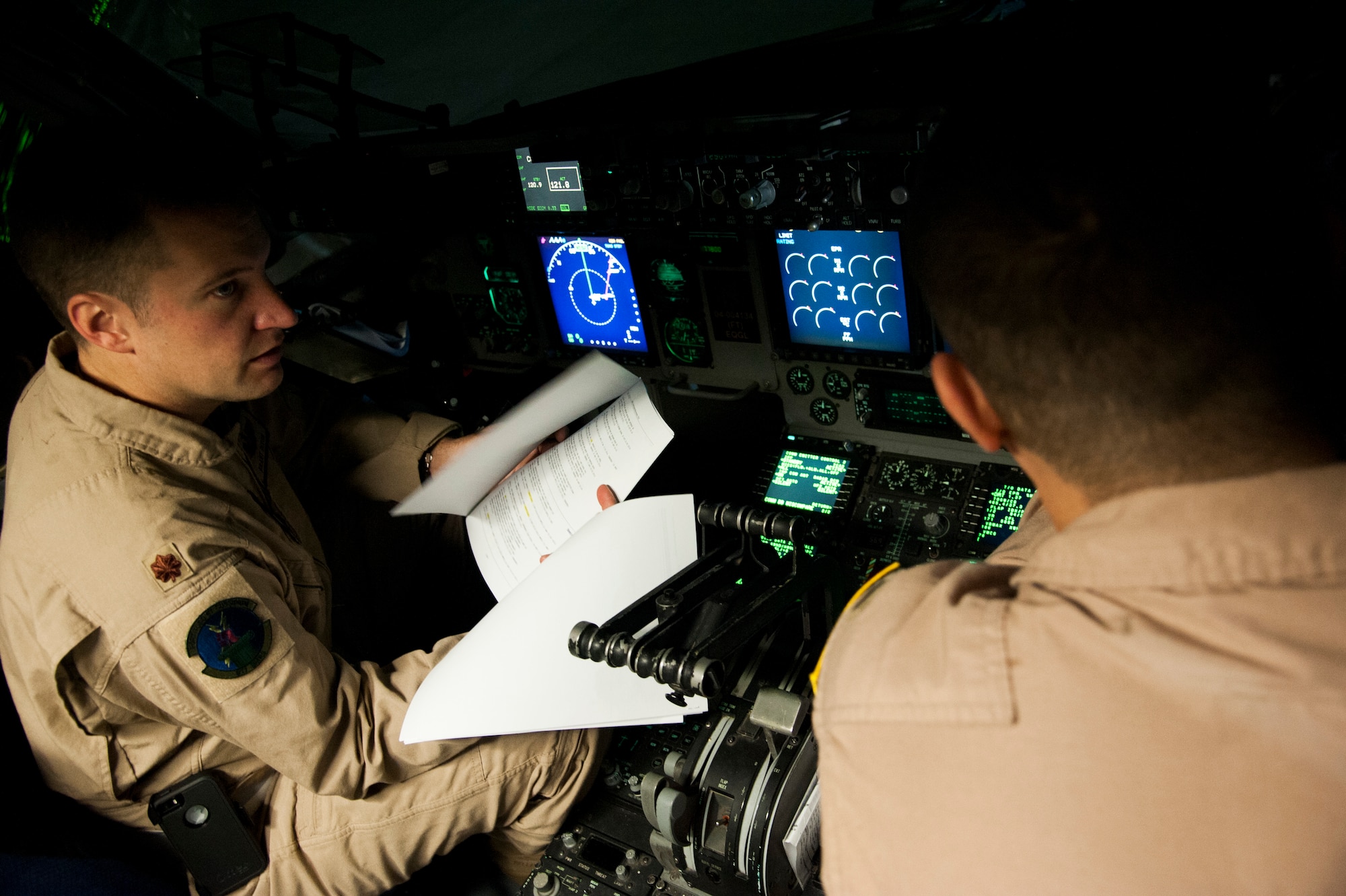 U.S. Air Force Maj. Brant Dixon, 817th Global Mobility Readiness Squadron Operations Officer and C-17 Globemaster III Instructor Pilot, commands a special two-part flying mission with the 6th Airlift Squadron, Joint Base McGuire-Dix-Lakehurst, N.J. Nov. 17-28. The mission was in support of Operation UNITED ASSISTANCE and an U.S. Air Force Special Operations team downrange. (U.S. Air Force photo/Staff Sgt. Destinie Berry/RELEASED)