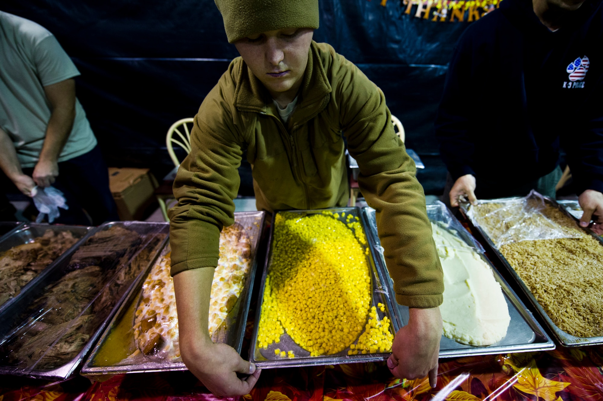 U.S. Air Force Airman 1st Class Thomas Clark prepares to serve meals at the Langley Transit Center as part of their Thanksgiving celebration at Joint Base Langley-Eustis, Va., during their controlled monitoring period, Nov. 27, 2014. The members recently returned from Liberia supporting Operation United Assistance, a Department of Defense operation in Liberia to provide logistics, training and engineering support to U.S. Agency for International Development-led efforts to contain the Ebola virus outbreak in West Africa. (U.S. Air Force photo by Staff Sgt. Gustavo Gonzalez/Released)