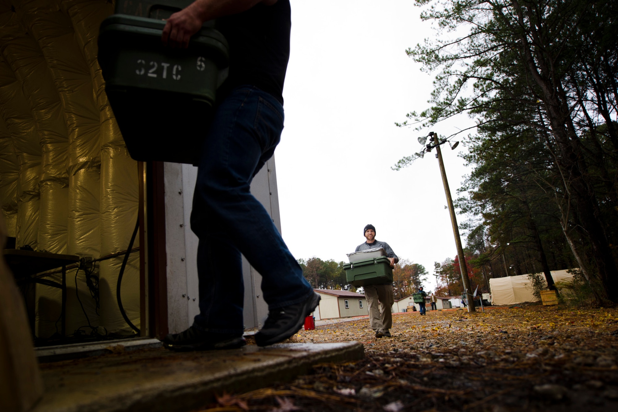 U.S. Service members help bring food to the dining facility at the Langley Transit Center as part of their Thanksgiving celebration at Joint Base Langley-Eustis, Va., during their controlled monitoring period, Nov. 27, 2014. The members recently returned from Liberia supporting Operation United Assistance, a Department of Defense operation in Liberia to provide logistics, training and engineering support to U.S. Agency for International Development-led efforts to contain the Ebola virus outbreak in West Africa. (U.S. Air Force photo by Staff Sgt. Gustavo Gonzalez/Released)