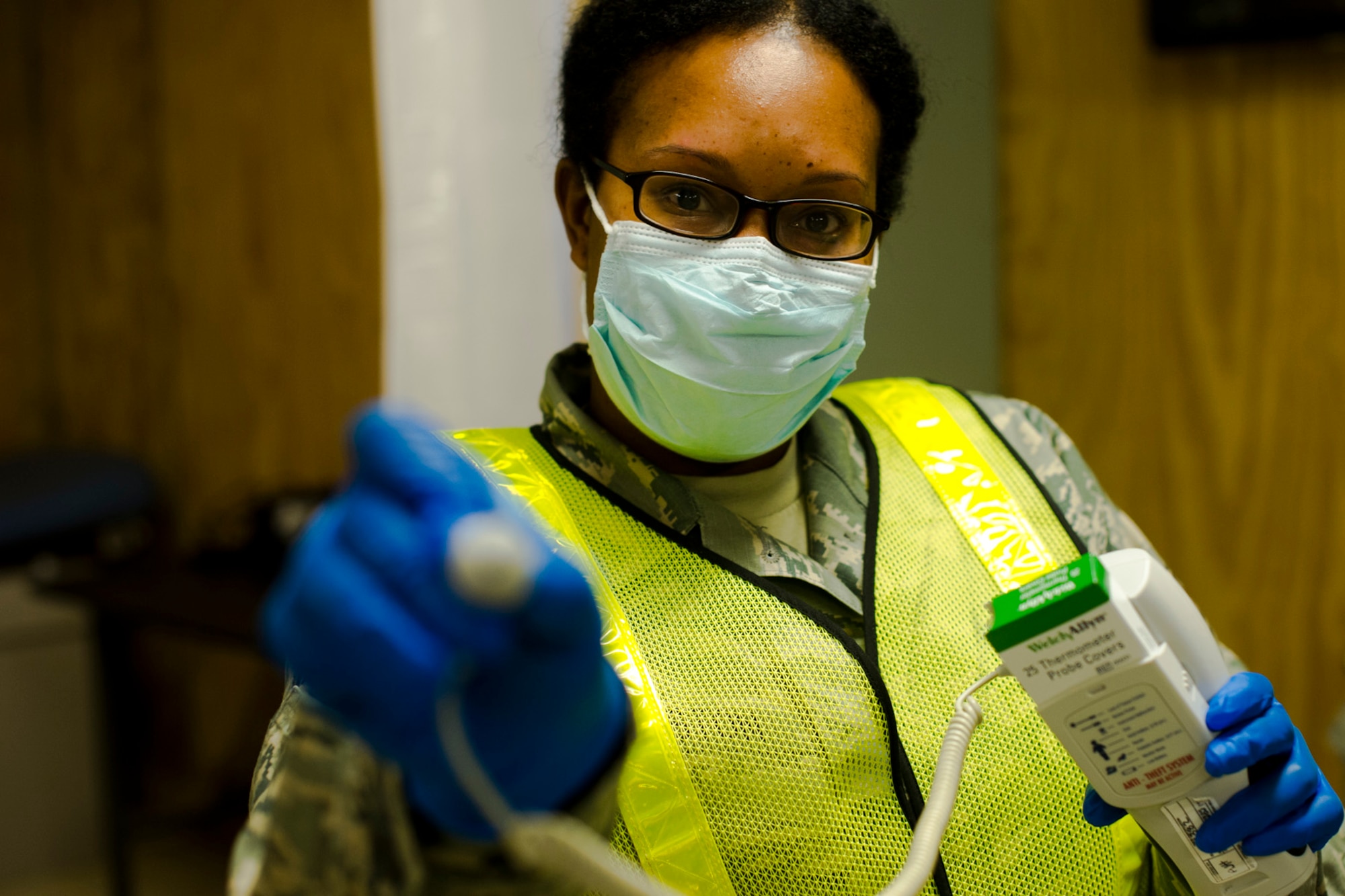 A U.S. Air Force Airman takes the temperature of Service members at the Langley Transit Center before their Thanksgiving celebration at Joint Base Langley-Eustis, Va., during their controlled monitoring period, Nov. 27, 2014. The members recently returned from Liberia supporting Operation United Assistance, a Department of Defense operation in Liberia to provide logistics, training and engineering support to U.S. Agency for International Development-led efforts to contain the Ebola virus outbreak in West Africa. (U.S. Air Force photo by Staff Sgt. Gustavo Gonzalez/Released)