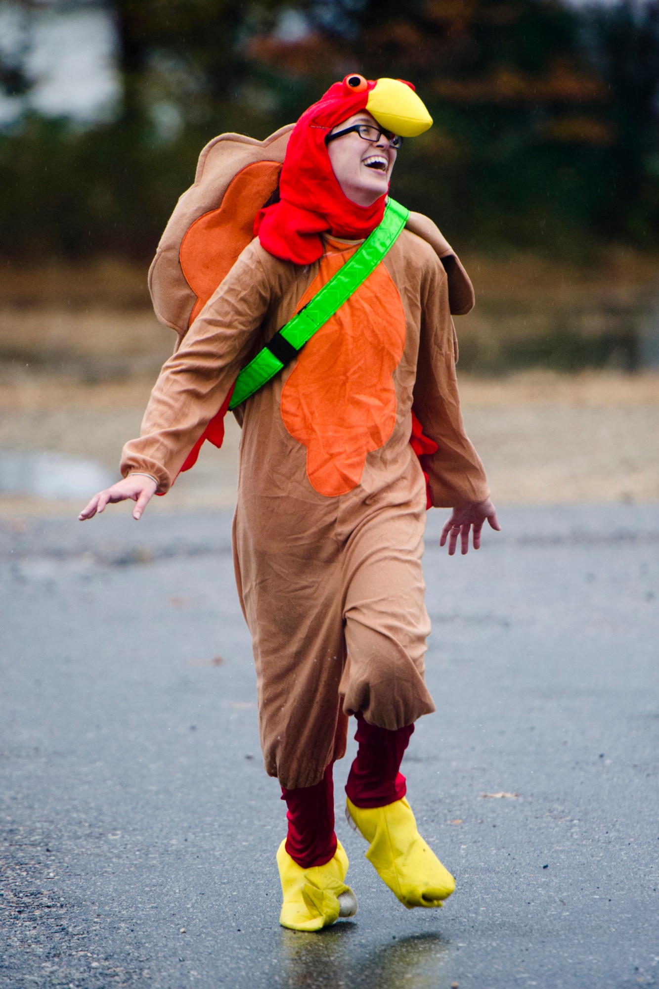 U.S. Air Force Maj. Danielle Miller, 87th Medical Group doctor stationed at Joint Base McGuire-Dix-Lakehurst, N.J., runs in a turkey suit during the Thanksgiving Turkey Trot 3K run at the Langley Transit Center as part of their Thanksgiving celebration at Joint Base Langley-Eustis, Va., during their controlled monitoring period, Nov. 27, 2014. The members recently returned from Liberia supporting Operation United Assistance, a Department of Defense operation in Liberia to provide logistics, training and engineering support to U.S. Agency for International Development-led efforts to contain the Ebola virus outbreak in West Africa. (U.S. Air Force photo by Staff Sgt. Gustavo Gonzalez/Released) 