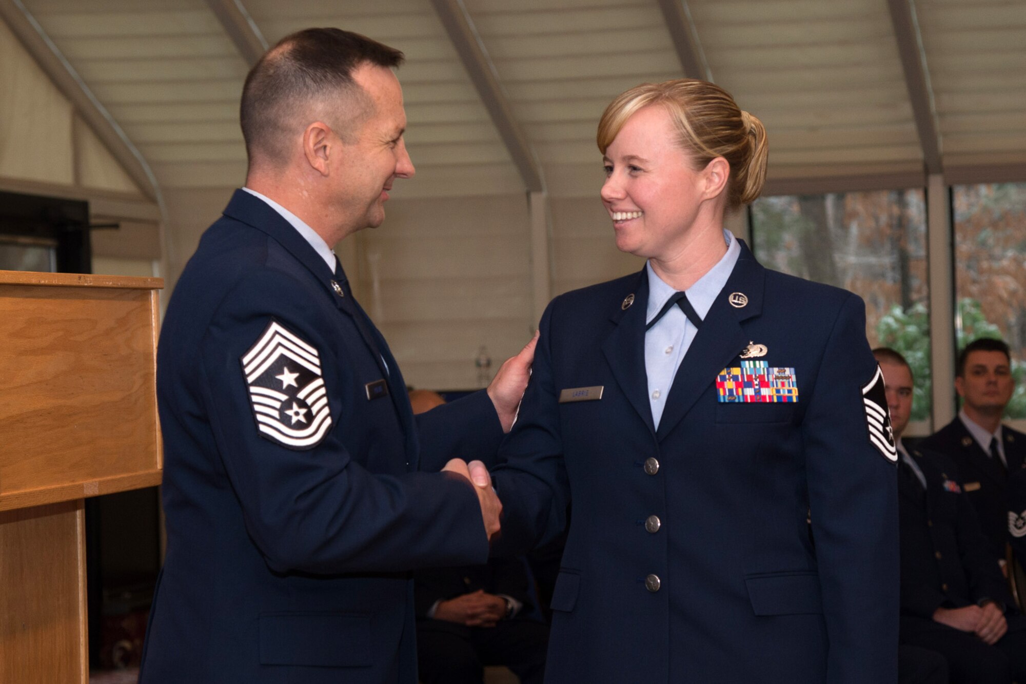 Hanscom Air Force Base Command Chief Master Sgt. Craig A. Poling congratulates newly promoted Master Sgt. Jessica Labrie, Battle Management Directorate, during the monthly enlisted promotion ceremony at the Minuteman Commons Nov. 26. The monthly enlisted promotion ceremony, generally held the last duty day of the month gives the Hanscom community a chance to recognize enlisted Airman selected for promotion. (U.S. Air Force photo by Mark Herlihy)