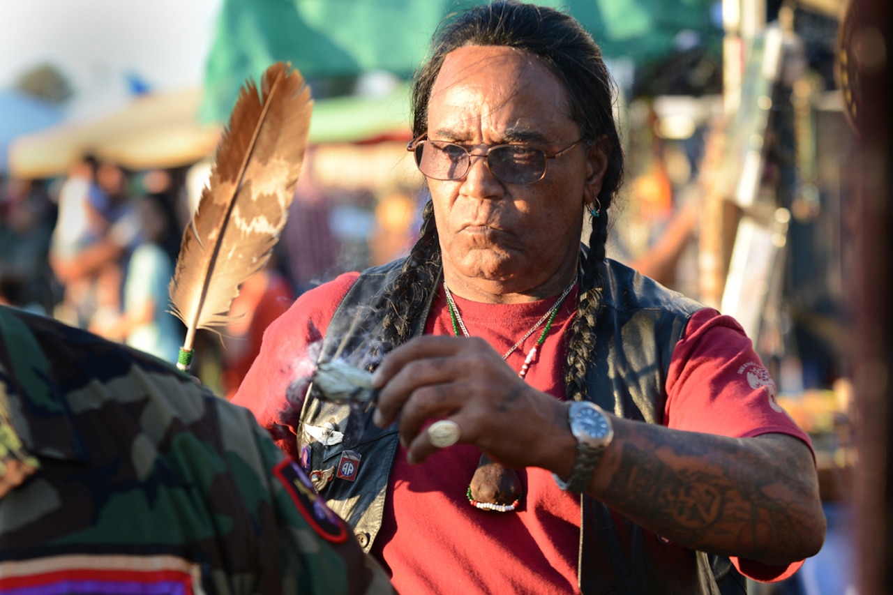 Tony LittleHawk, an Army Vietnam veteran, Cherokee tribe member and sun dancer, performs a spiritual cleansing and prayer with white sage he picked himself during the Native American Veterans Association's annual Veterans Appreciation and Heritage Day Pow Wow in South Gate, Calif., Nov. 8, 2014. DoD photo by Marvin Lynchard
