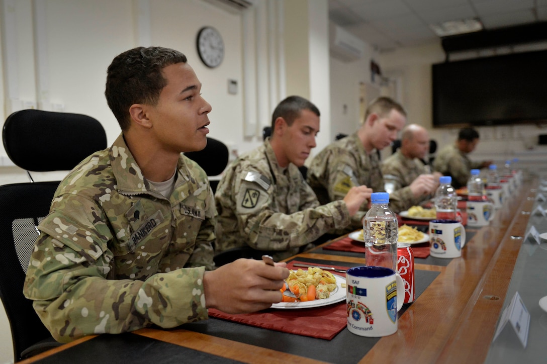 U.S. Army Spc. Troy Bankerd introduces himself to U.S. Deputy Defense Secretary Bob Work during a luncheon with soldiers assigned to the International Security Assistance Force Joint Command in Kabul, Afghanistan, Nov. 28, 2014. During the lunch, Work invited the troops to engage in an open discussion.