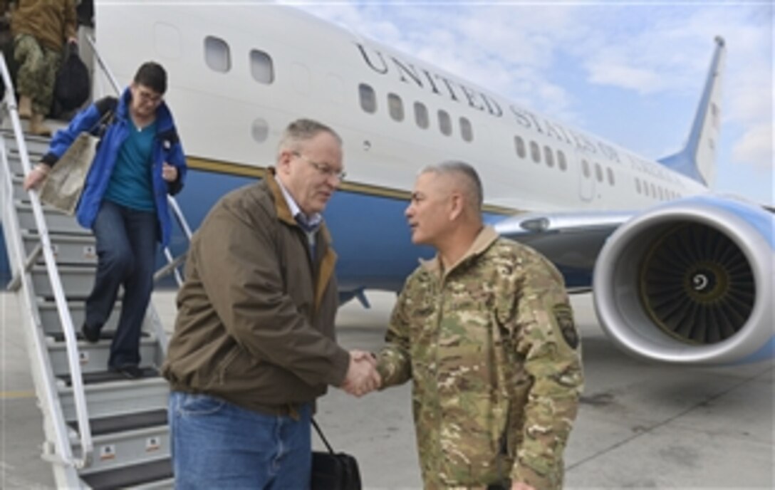 U.S. Deputy Defense Secretary Bob Work shakes hands with Army Gen. John F. Campbell, commander of the International Security Assistance Force, upon the deputy secretary's arrival in Kabul, Afghanistan,  Nov. 27, 2014. Work visited forward bases to thanks service members for their service and to share Thanksgiving meals with them. 
