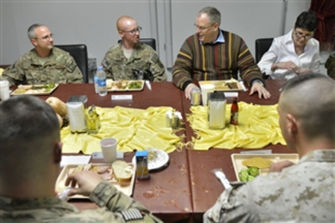 U.S. Deputy Defense Secretary Bob Work and his wife, Cassandra, right, join U.S. service members for Thanksgiving dinner on Bagram Airfield, Afghanistan, Nov. 27, 2014. Work traveled to Afghanistan to personally thank deployed troops on Thanksgiving Day for their service and sacrifice this holiday season. 