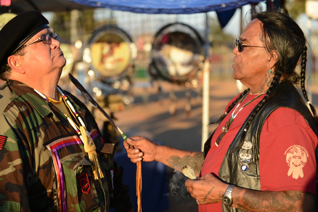 Marine Corps veteran Antonio Quezada receives a spiritual cleansing and prayer from Native American Veterans Association's spiritual adviser Tony LittleHawk, an Army Vietnam veteran, during the Native American Veterans Association's annual Veterans Appreciation and Heritage Day Pow Wow in South Gate, Calif., Nov. 8, 2014. Quezada is from the White Mountain Apache tribe and LittleHawk is from the Cherokee tribe.