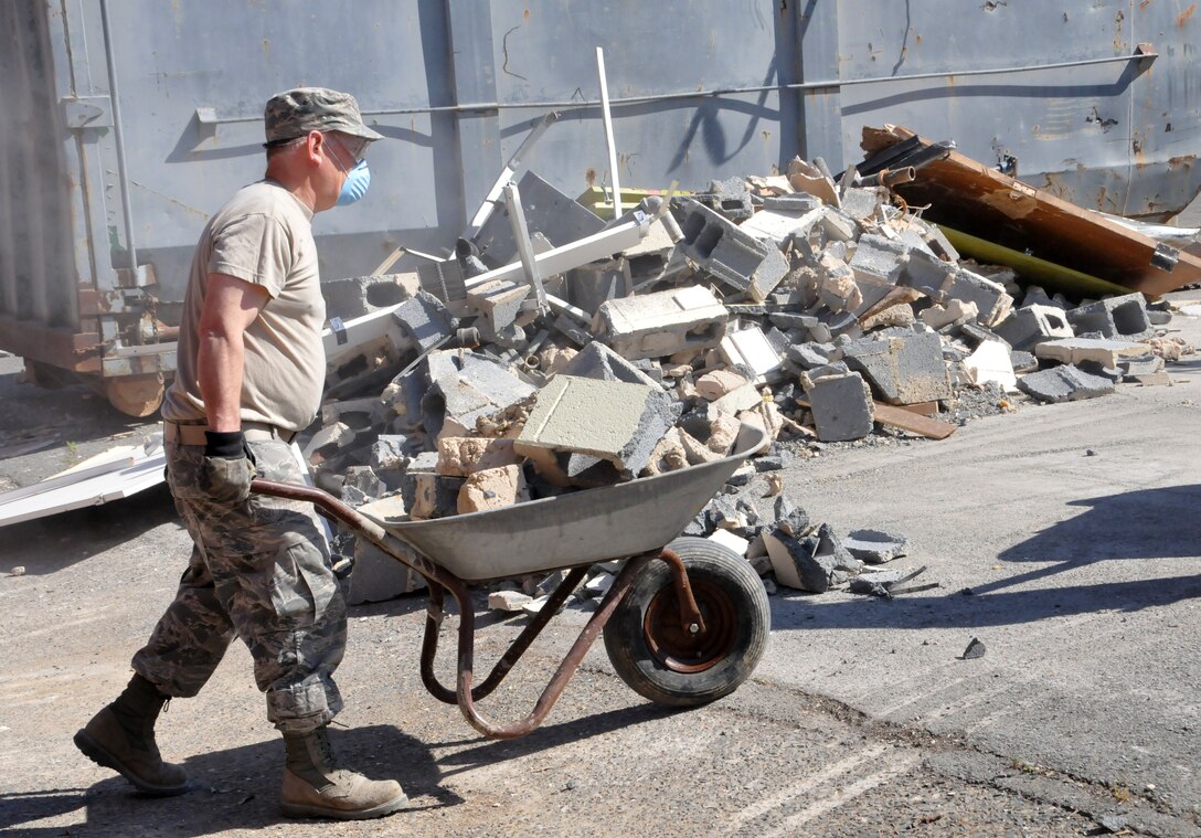 S. Air Force Tech. Sgt. Kevin Fitts, 145th Civil Engineer Squadron, hauls out demolished wall materials for recycling, May 4, 2014, in New London, N.C. The demolition is part of an ongoing project to renovate and transform an abandoned school into a 2nd Tarheel ChalleNGe site scheduled to open May 2015. Tarheel ChalleNGe is a quasi-military style program that helps teens, ages 16 to 18, get their GED and develop life coping skills to prepare them for future employment or further education endeavors. (U.S. Air National Guard photo by Master Sgt. Patricia F. Moran, 145th Public Affairs/Released)