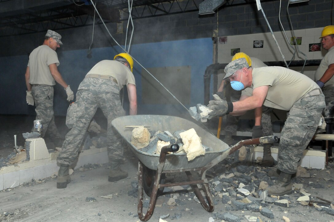 Members of the 145th Civil Engineer Squadron get valuable training while removing interior partition walls and electrical wiring from abandoned school, May 4, 2014, in New London, N.C. The school campus is being renovated and transform into a 2nd Tarheel ChalleNGe site scheduled to open May 2015. Tarheel ChalleNGe is a quasi-military style program that helps teens, ages 16 to 18, get their GED and develop life coping skills to prepare them for future employment or further education endeavors. (U.S. Air National Guard photo by Master Sgt. Patricia F. Moran, 145th Public Affairs/Released)