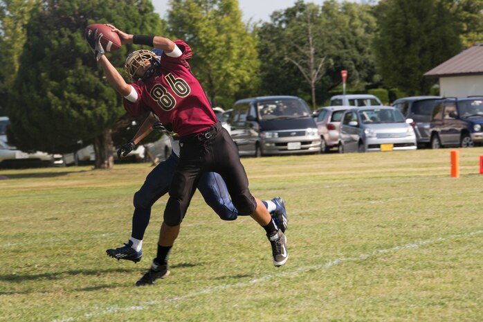 Tyson Moore, Samurai wide receiver and defensive back, intercepts the ball during Matthew C. Perry High School’s first home game, Sept. 27, 2014, aboard Marine Corps Air Station Iwakuni, Japan. The Samurai are participating in their first varsity season in 11 years.