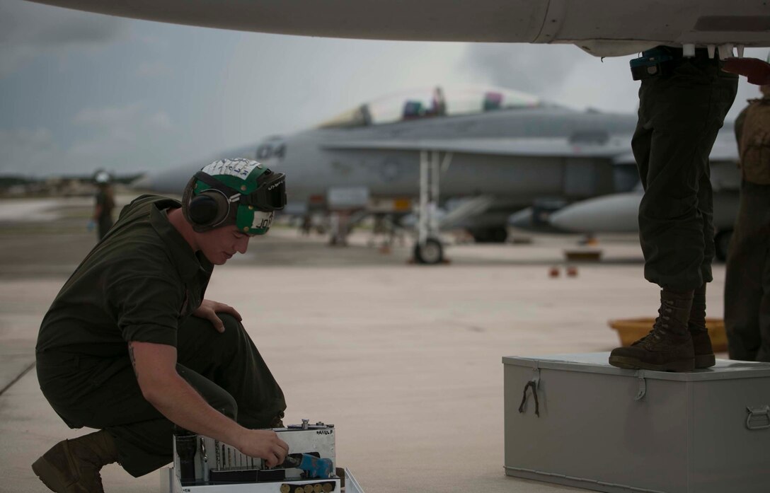 Lance Cpl. Grant W. Jones, from Pocola, Okla., looks through a toolbox Sept. 29 during Forager Fury III on Andersen Air Force Base. He is helping another Marine as they conduct routine maintenance  on an FA-18 Hornet. Jones is an airframes mechanic with Marine All Weather Fighter Attack Squadron 242, Marine Aircraft Group 12, 1st Marine Aircraft Wing, III Marine Expeditionary Force. (U.S. Marine Corps photo by Lance Cpl. Tyler Ngiraswei/ Released)