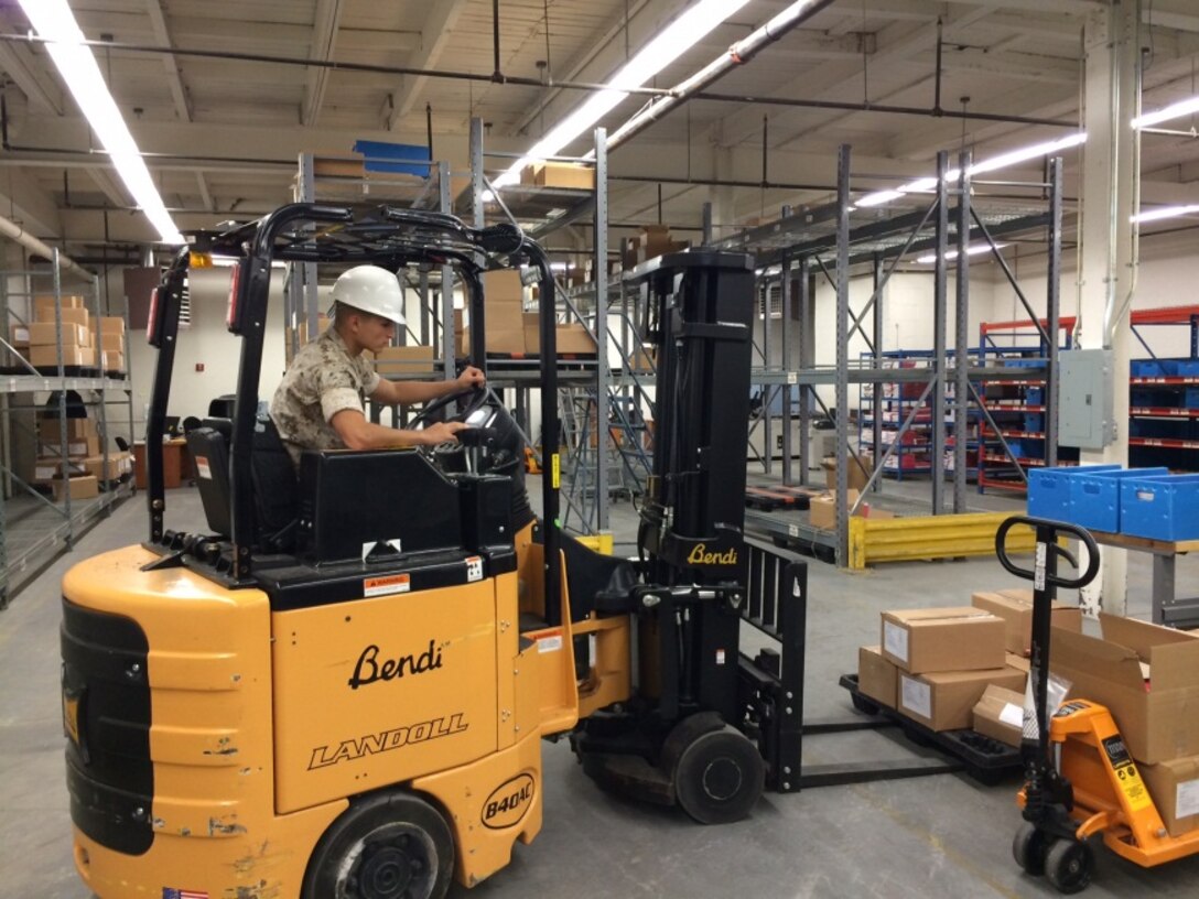 Lance Cpl. Jose L. Cruz manages stocks of Marine Corps Institute Course Redbooks in the logistics warehouse. Lance Cpl. Cruz is a 3051 Warehouse Clerk, originally from Denver, currently assigned to the MCI Logistics Section.