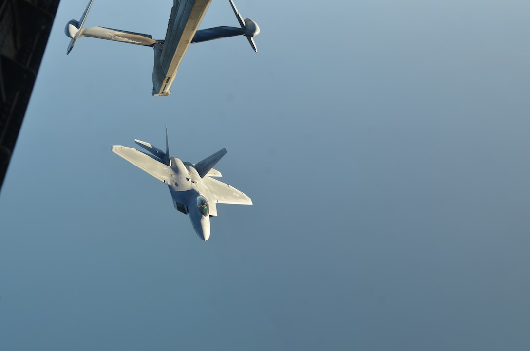 A U.S Air Force F-22 Raptor fighter aircraft leaves a KC-10 Extender after refueling over northern Iraq after conducting air strikes in Syria, September 23, 2014. These aircraft were part of a large coalition strike package that was the first to strike ISIL targets in Syria. (U.S. Air Force photo by Maj. Jefferson S. Heiland)