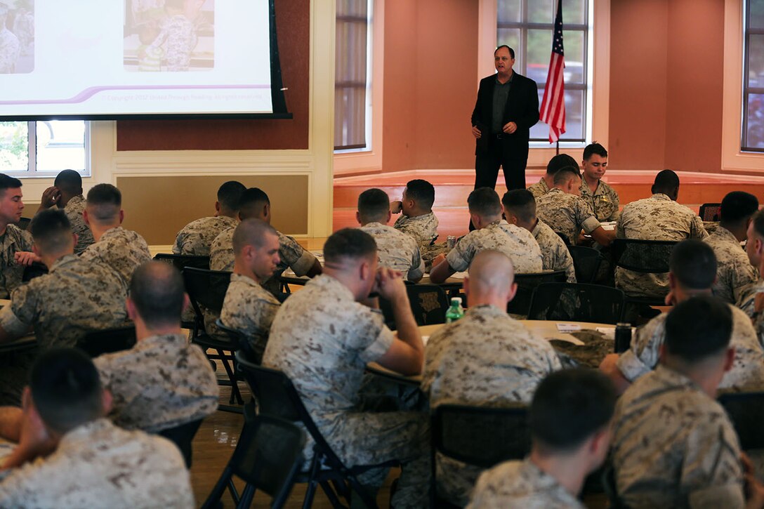 Jim Stolarczyk, the family readiness officer, or FRO, with the 24th Marine Expeditionary Unit’s Command Element, speaks to Marines and Sailors during a pre-deployment brief at Marston Pavilion aboard Camp Lejeune, N.C., Sept. 30, 2014. Service members received classes and instructions regarding personal belongings and family affairs in preparation of the deployment at the end of the year. 