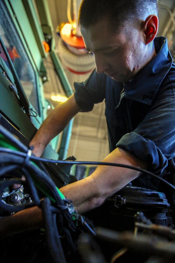 Lance Cpl. Kevin J. Brunick, a motor transportation mechanic with the 24th Marine Expeditionary Unit’s Logistics Combat Element, Combat Logistics Battalion 24, and native of Troy, N.Y., repairs a Medium Tactical Vehicle Replacement, or 7-Ton, engine at Camp Lejeune, N.C., Sept. 30, 2014. Marines with the unit performed maintenance on vehicles in preparation for Composite Training Unit Exercise, the fourth major pre-deployment exercise in preparation of the deployment at the end of the year.
