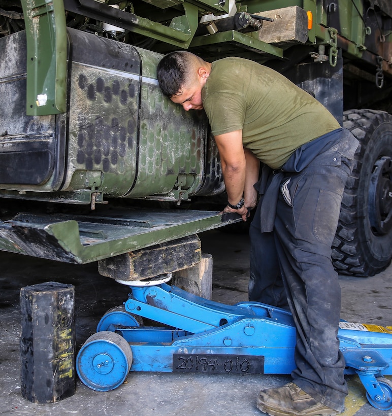 Lance Cpl. Aaron Crissnan, a motor transportation mechanic with the 24th Marine Expeditionary Unit’s Logistics Combat Element, Combat Logistics Battalion 24, and native of Findlay, Ohio, installs the belly pan on a Medium Tactical Vehicle Replacement, or 7-Ton, at Camp Lejeune, N.C., Sept. 30, 2014. Marines with the unit performed maintenance on vehicles in preparation for Composite Training Unit Exercise, the fourth major pre-deployment exercise in preparation of the deployment at the end of the year.