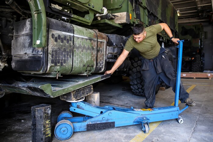 Lance Cpl. Aaron Crissnan, a motor transportation mechanic with the 24th Marine Expeditionary Unit’s Logistics Combat Element, Combat Logistics Battalion 24, and native of Findlay, Ohio, installs the belly pan on a Medium Tactical Vehicle Replacement, or 7-Ton, at Camp Lejeune, N.C., Sept. 30, 2014. Marines with the unit performed maintenance on vehicles in preparation for Composite Training Unit Exercise, the fourth major pre-deployment exercise in preparation of the deployment at the end of the year.