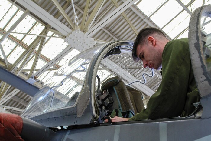 Sergeant Jonpaul Wise, a MOS HERE, and a quality assurance representative with Marine Medium Tiltrotor Squadron 365 (Reinforced), 24th Marine Expeditionary Unit, conducts maintenance on the SJU-4/A ejection seat of an AV-8B Harrier at Marine Corps Air Station Cherry Point, N.C., Sept. 30, 2014. VMM-365 (Rein) is preparing for Composite Training Unit Exercise, the fourth major pre-deployment exercise in preparation of the deployment at the end of the year. Wise is a native of Winston-Salem, N.C.