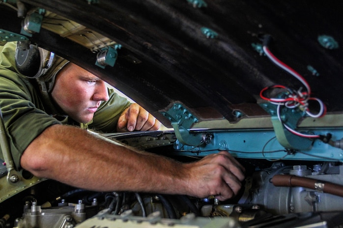 Lance Cpl. Dalton C. Bailey, a plane captain with Marine Medium Tiltrotor Squadron 365 (Reinforced), 24th Marine Expeditionary Unit, and a native of Pittsburg, Pa., removes a bolt from the blade of an AV-8B Harrier engine at Marine Corps Air Station Cherry Point, N.C., Sept. 30, 2014. VMM-365 (Rein) conducts maintenance to make sure all aircraft are prepared for Composite Training Unit Exercise, the fourth major pre-deployment exercise in preparation of the deployment at the end of the year.