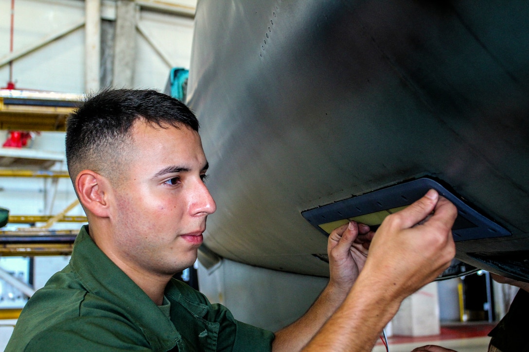 Private First Class Freddy Amaya, an avionics technician with Marine Medium Tiltrotor Squadron 365 (Reinforced), 24th Marine Expeditionary Unit, and a native of Siloam Springs, Ark., changes the form light of an AV-8B Harrier at Marine Corps Air Station Cherry Point, N.C., Sept. 30, 2014. VMM-365 (Rein) conducts maintenance to make sure all aircraft are prepared for Composite Training Unit Exercise, the fourth major pre-deployment exercise in preparation of the deployment at the end of the year.