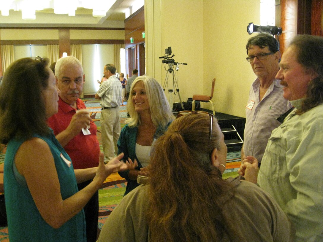 Donnie Kinard (second from left), chief of the Regulatory Division and Tori White (third from left), deputy chief, chat with attendees during a break at the Fort Lauderdale, Florida Open House July 11. 