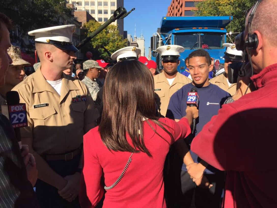 GySgt Luke Penniman and Future Marine Kason Smith are interviewed at the FOX 29 Salutes the Troops event on September 26, 2014. 